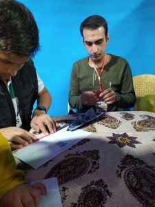 alt: آموزش ساخت موشک کاغذی برای کودکان در غرفه علمی شرکت ما در جشنواره کودک و نوجوان اصفهان